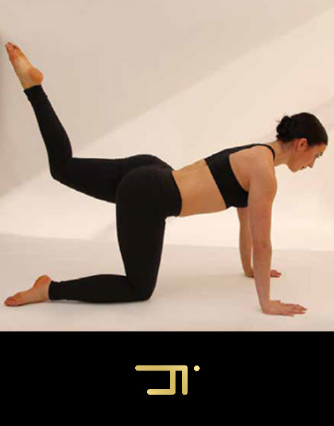 A woman in black pants and top doing yoga.