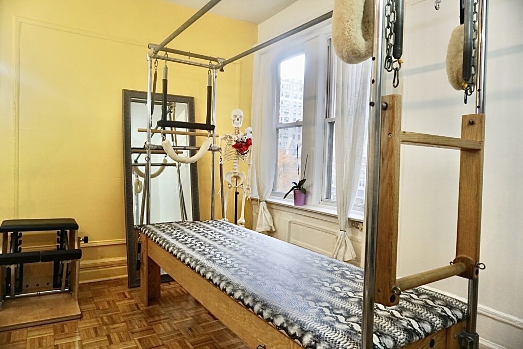 A bed with a wooden frame and metal bars.